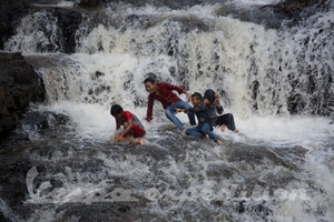 Locals know how to enjoy attractions. Try this in waterfall back home :o)